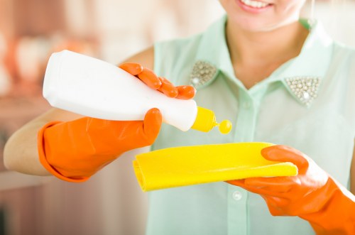 Technician sorting cleaning packaging for recycling after a carpet cleaning job
